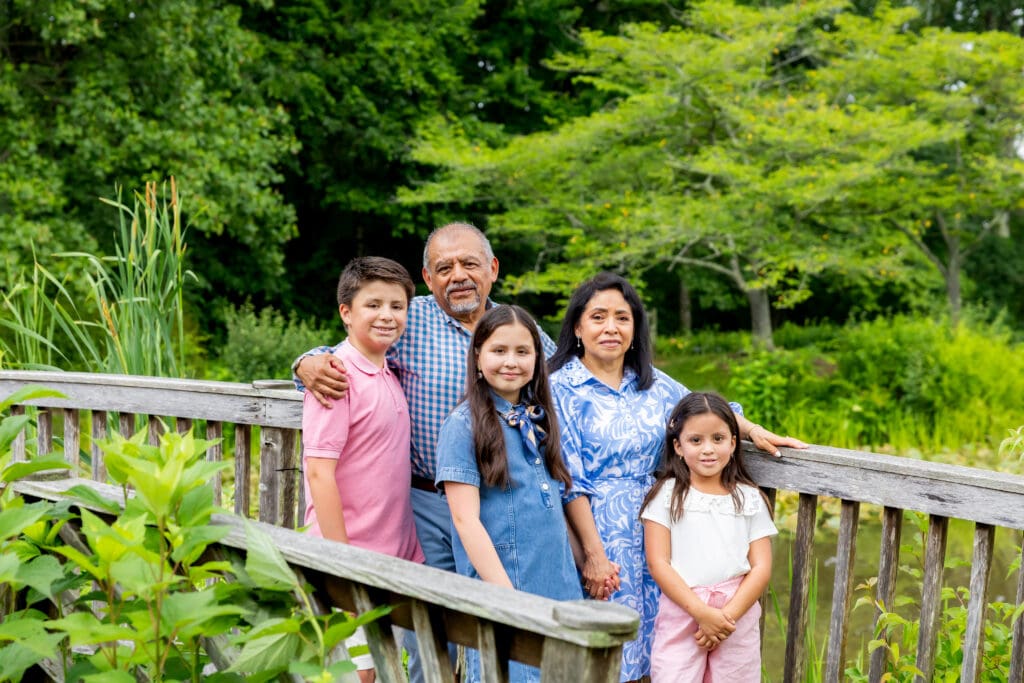 Grandparents, and three children sitting together in front of lush greenery during a Meadowlark Botanical Gardens family session – captured by Capture Joy Photography, Northern Virginia family photographer.