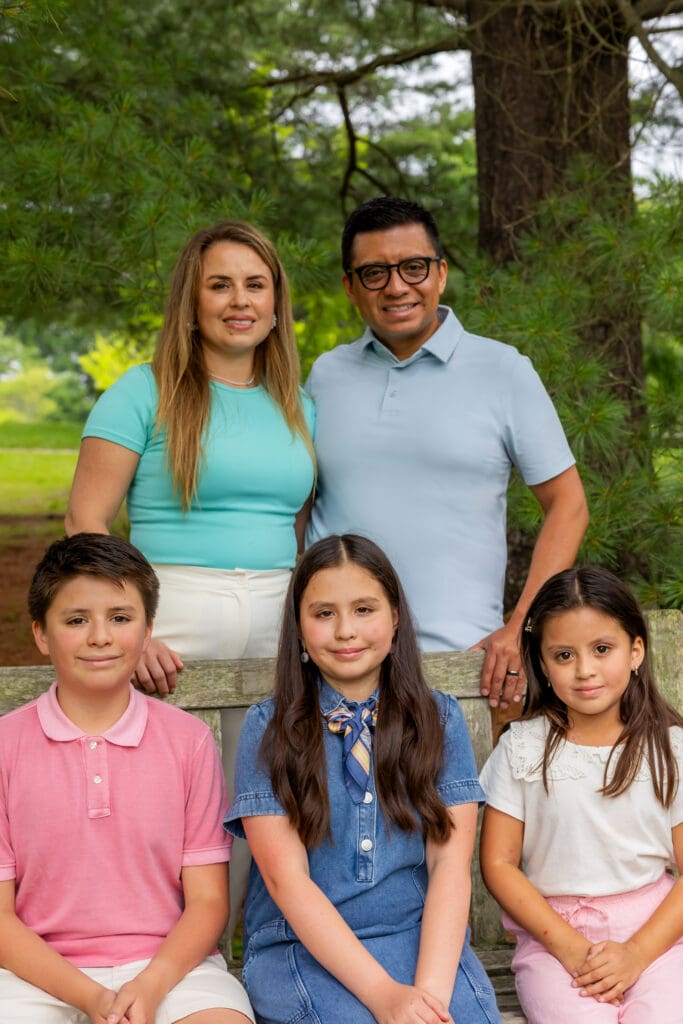 Parents with their three children sitting for a portrait in the gardens of Meadowlark – captured by Capture Joy Photography, Northern Virginia family photographer.